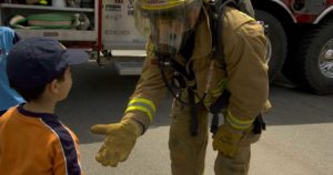 Firefighter gives child a five